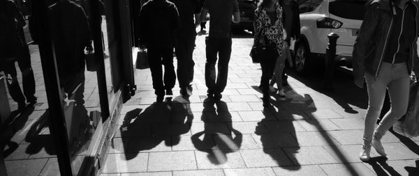 Low section of people walking on street