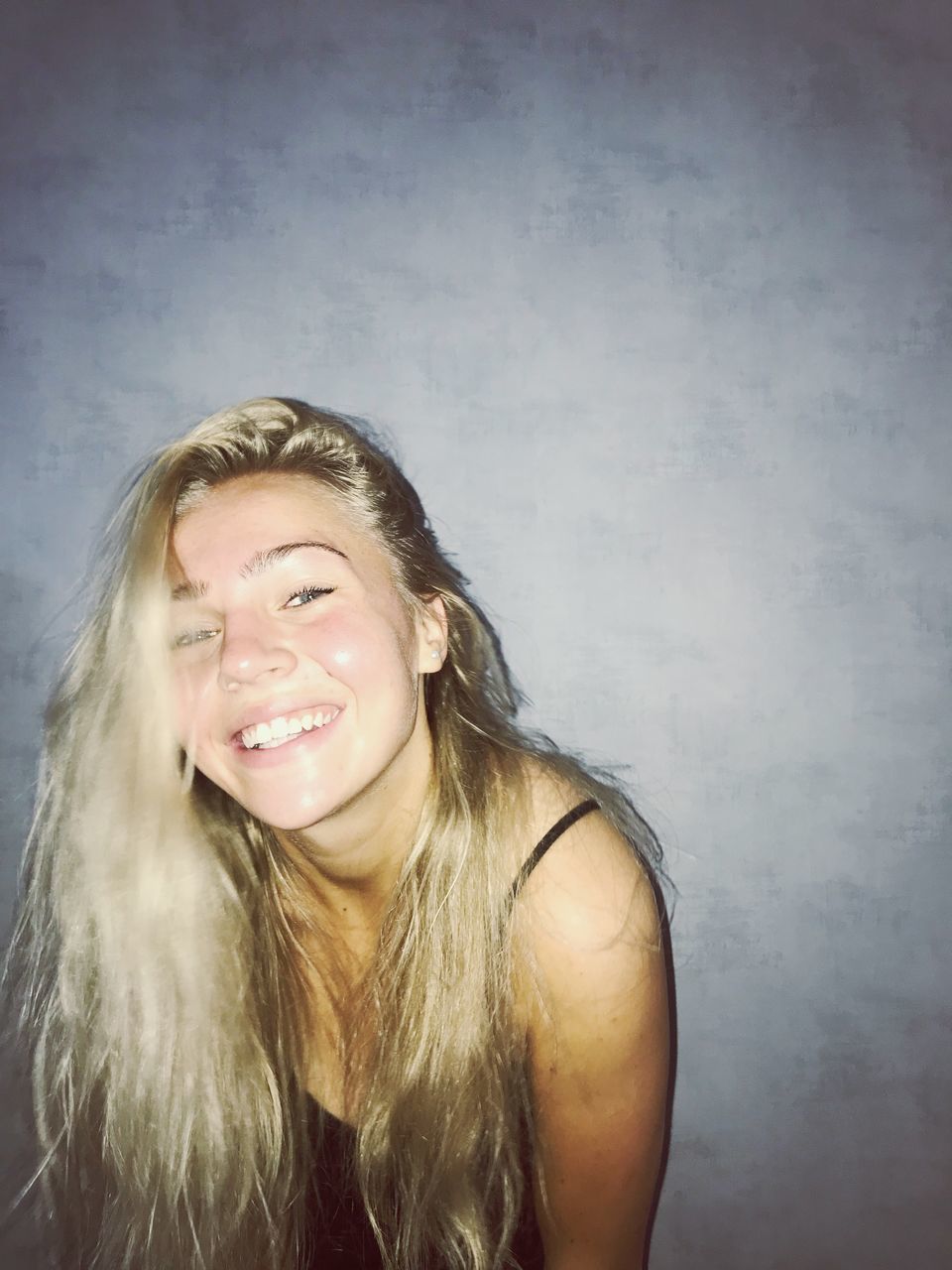 smiling, happiness, young adult, blond hair, emotion, one person, hair, young women, portrait, front view, long hair, hairstyle, indoors, toothy smile, teeth, headshot, wall - building feature, women, beautiful woman, teenager, wavy hair