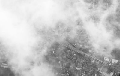 High angle view of smoke emitting from building in city