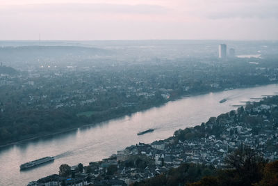 High angle view of river by buildings against sky