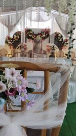 Flower vase on table against wall