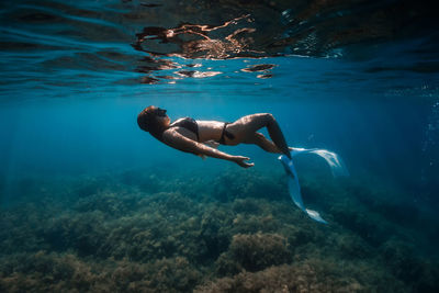 Young woman swimming in sea