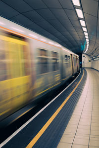 Blurred motion of train at railroad station