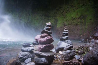 Close-up of statue against rocks in water