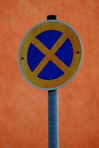 Close-up of arrow sign on road