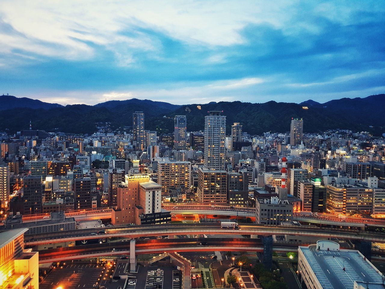 building exterior, built structure, architecture, sky, city, cityscape, cloud - sky, office building exterior, building, mountain, nature, skyscraper, no people, landscape, modern, residential district, high angle view, travel destinations, tall - high, outdoors, financial district