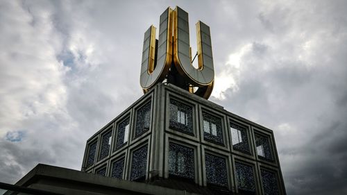 Low angle view of building against cloudy sky