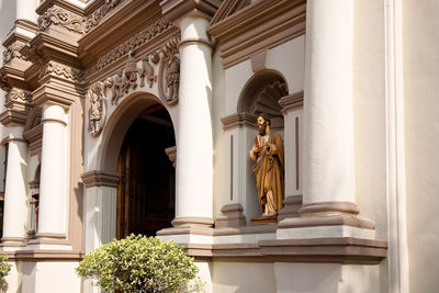 Low angle view of statue against building