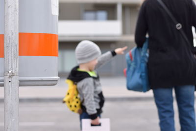 Mother and son standing on road