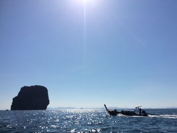 Silhouette boat in sea against clear sky