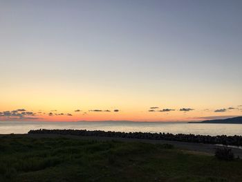 Scenic view of sea against clear sky during sunset