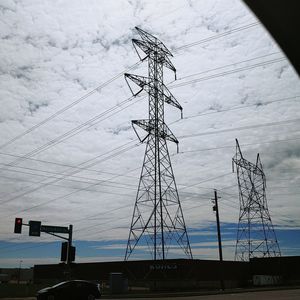 Low angle view of electricity pylon against sky
