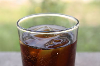 Close-up of beer glass on table cola