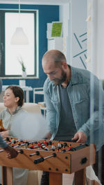 Side view of man working at table