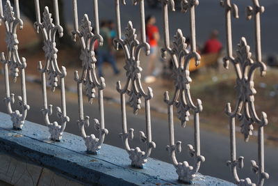 Close-up of chain hanging on railing