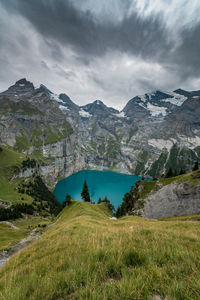 Scenic view of lake by mountains against sky