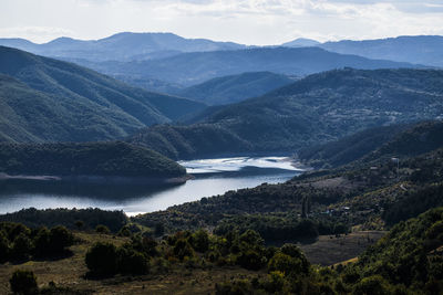 Scenic view of lake and mountains against sky