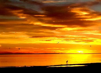 Scenic view of sea against orange sky