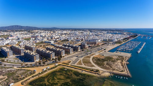 High angle view of buildings against blue sky