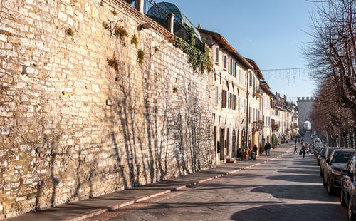 Footpath amidst buildings in city