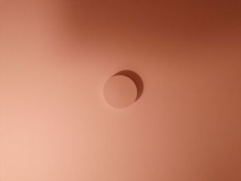 Low angle view of moon against orange sky