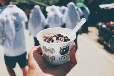 Close-up of hand holding ice cream