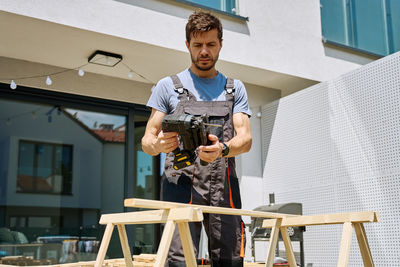 Portrait of young man standing in workshop