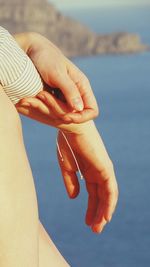 Cropped image of woman holding railing