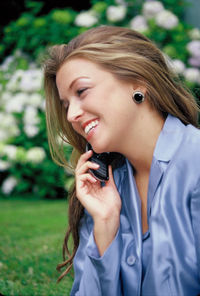 Young woman smiling while holding camera