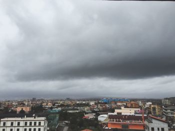 Buildings against cloudy sky