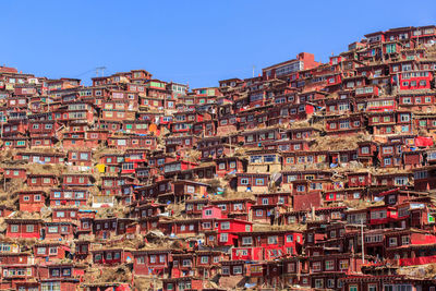 Low angle view of buildings against clear blue sky