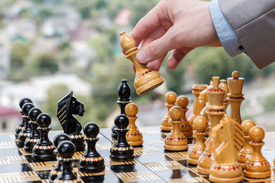 Midsection of person playing guitar on chess