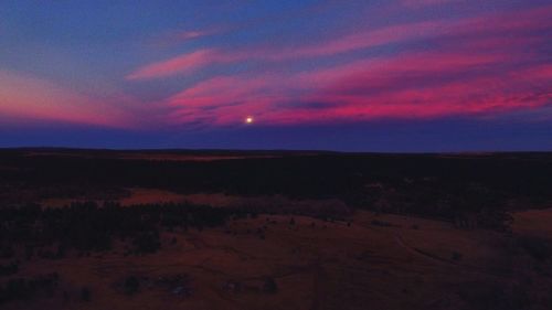 Scenic view of landscape against sky at night