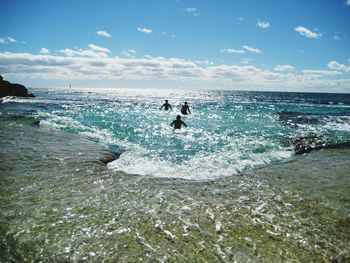 People enjoying summer in sea at rottnest island against sky on sunny day