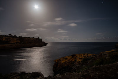 Scenic view of sea against sky at night