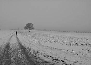 Scenic view of snow covered field against clear sky