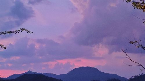 Low angle view of silhouette mountains against sky at sunset