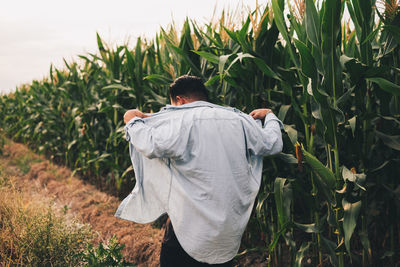 Rear view of man standing in field