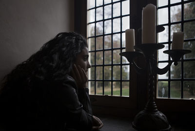 Close-up of teenage girl looking through window