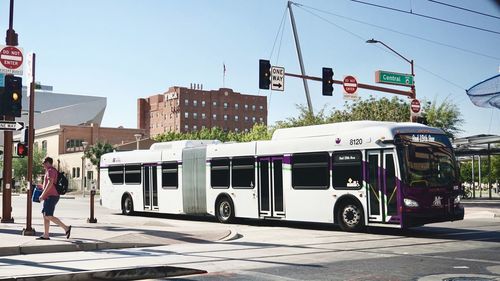 Vehicles on road against buildings in city