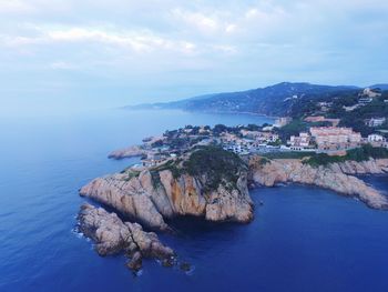 Scenic view of sea by city against sky