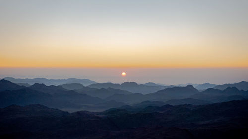 Scenic view of silhouette mountains against sky during sunset