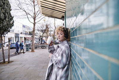 Woman looking at camera in city