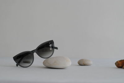 Close-up of sunglasses on table against white background