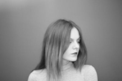 Portrait of beautiful woman against wall