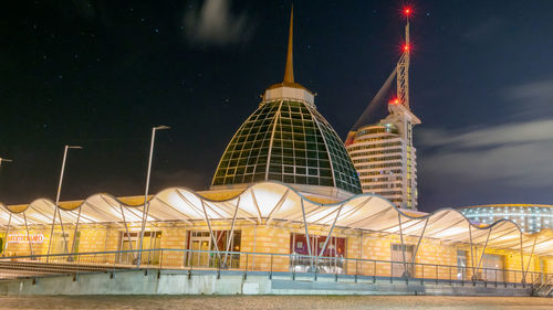 Illuminated building against sky at night