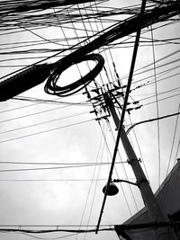 Low angle view of electricity pylon against sky