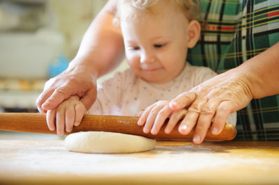 Close-up of cute girl preparing food at home