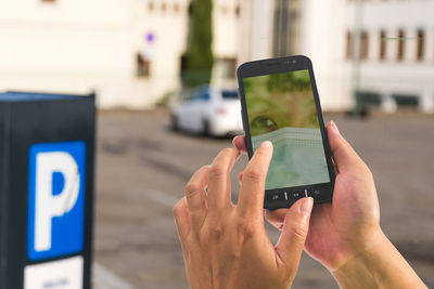 Midsection of man using mobile phone