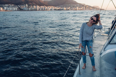 Woman standing on boat sailing in sea
